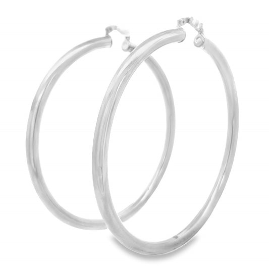 A pair of polished silver hoop earrings rests against a clean white background.