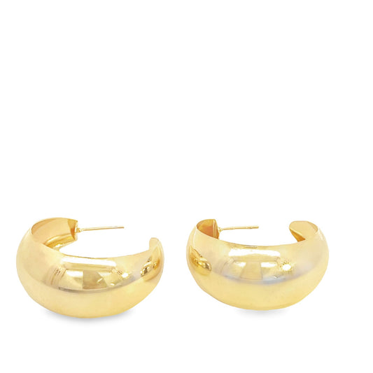A pair of thick gold hoop earrings rests against a clean white background.