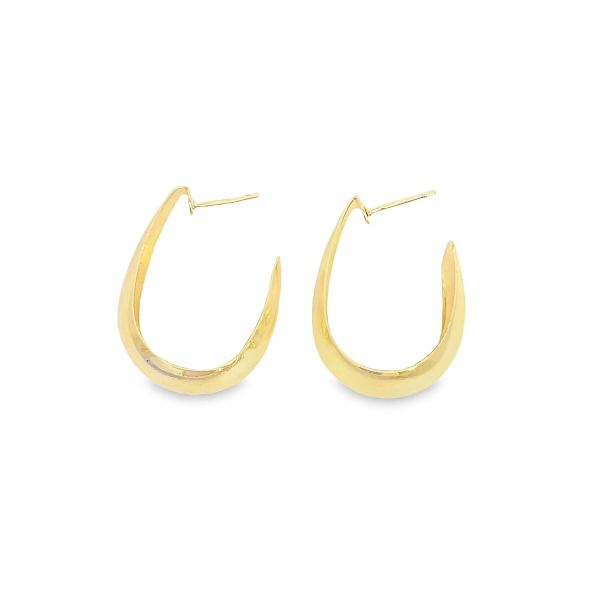 A pair of sleek, gold hoop earrings rests against a clean white background.
