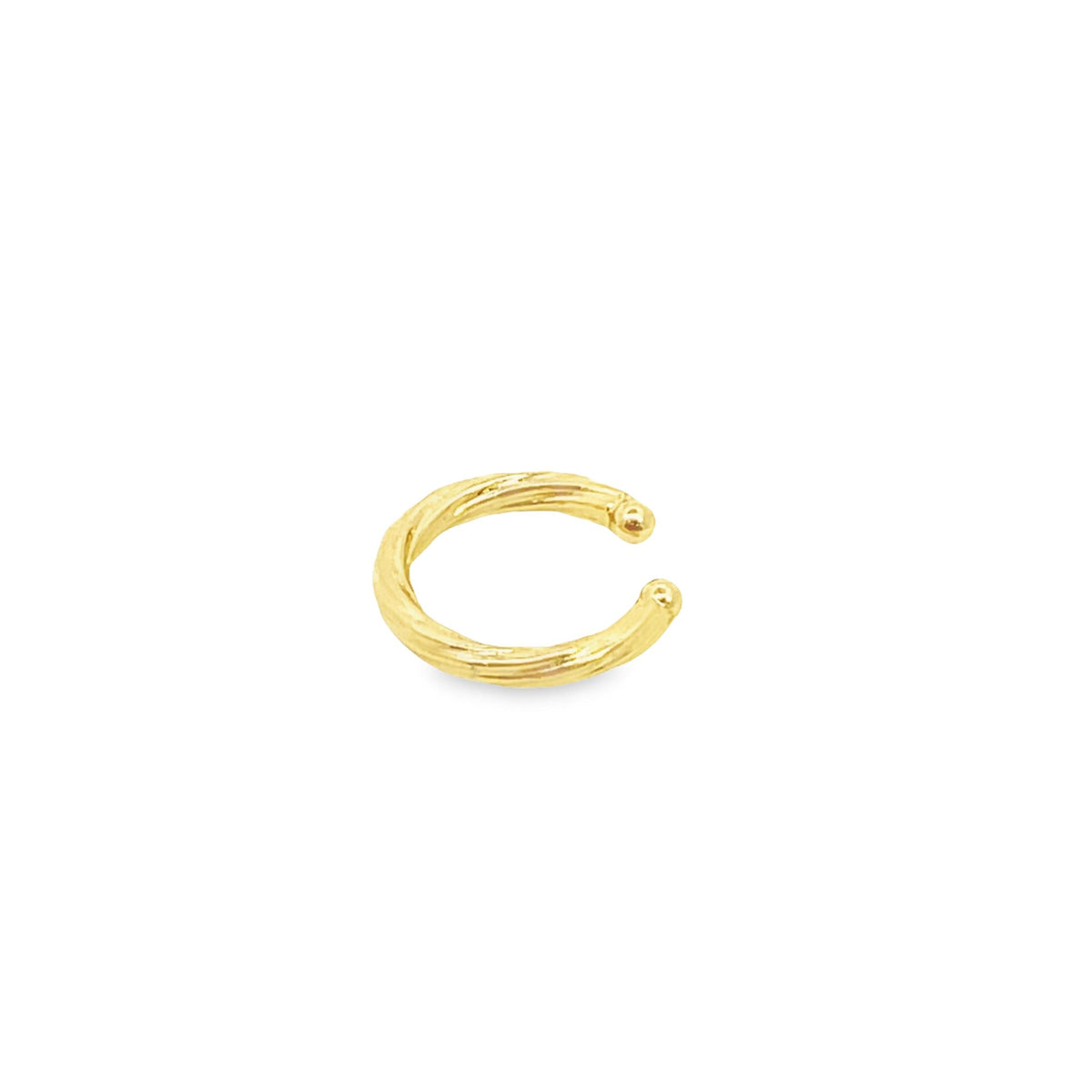A textured gold ear cuff rests against a clean white background.