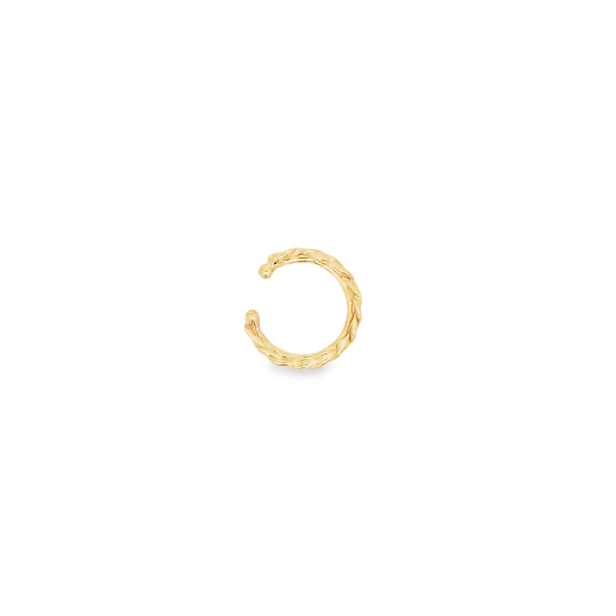 A textured gold ear cuff sits against a clean white background.