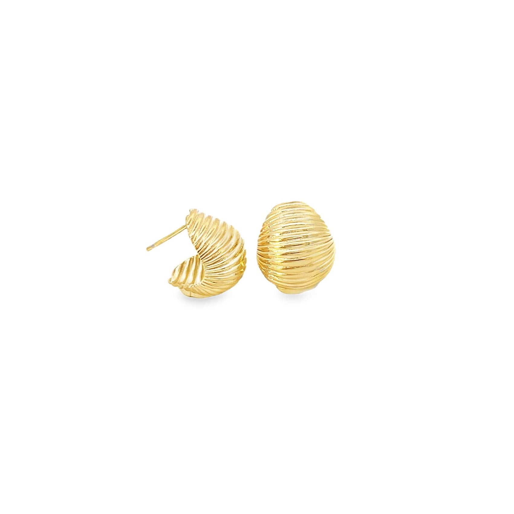 A pair of textured gold dome hoop earrings rests on a plain white background.
