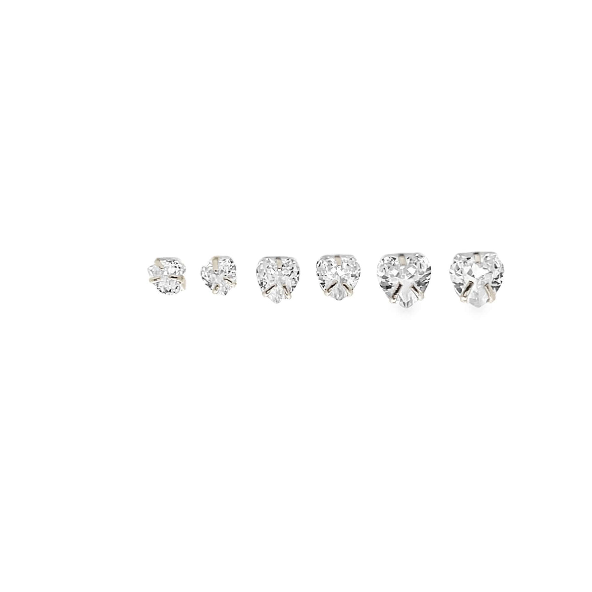 Six sparkling heart-shaped diamond stud earrings of increasing sizes align horizontally against a clean white background.
