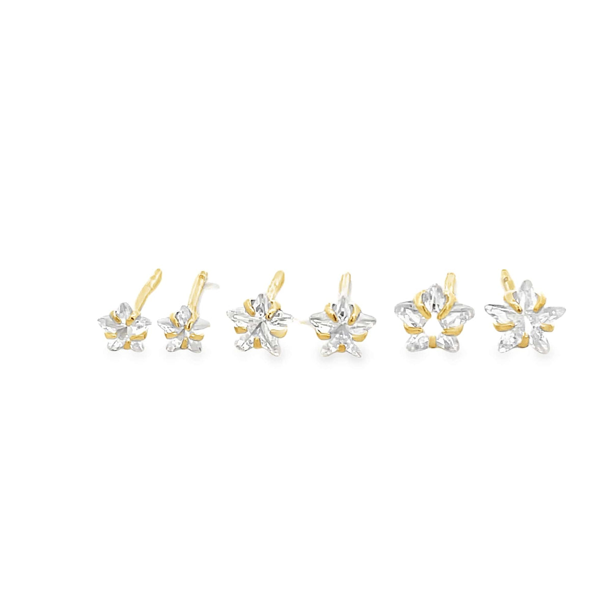 A row of six gold stud earrings features sparkling star-shaped cubic zirconia stones in graduating sizes against a clean white background.