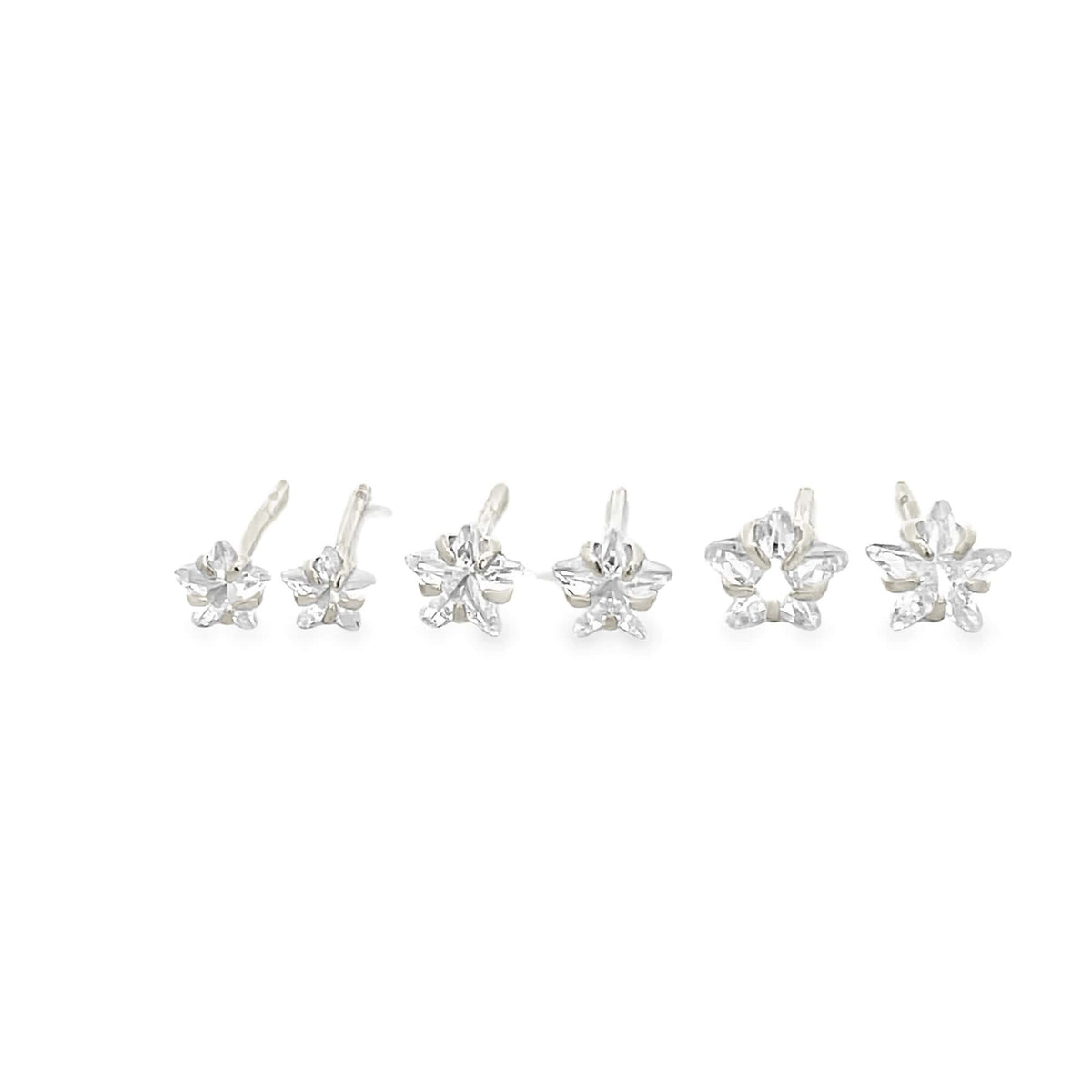 A row of six sparkling star-shaped cubic zirconia stud earrings with silver posts rests against a clean white background.