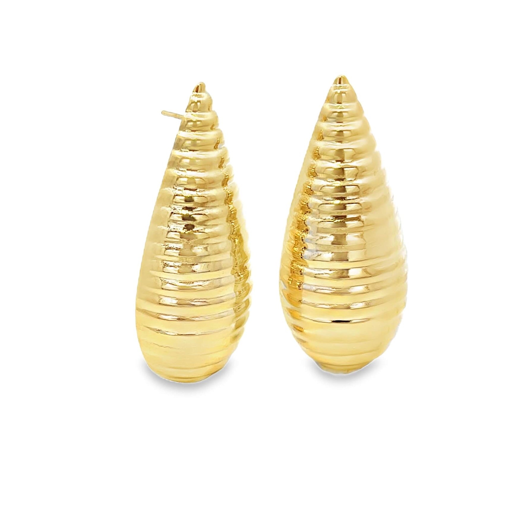 A pair of textured, teardrop-shaped gold earrings rests against a clean white background.