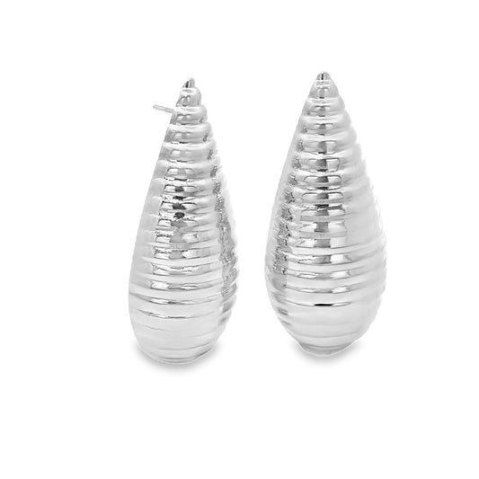 A pair of shiny silver teardrop earrings with a textured, ribbed design rests against a clean white background.