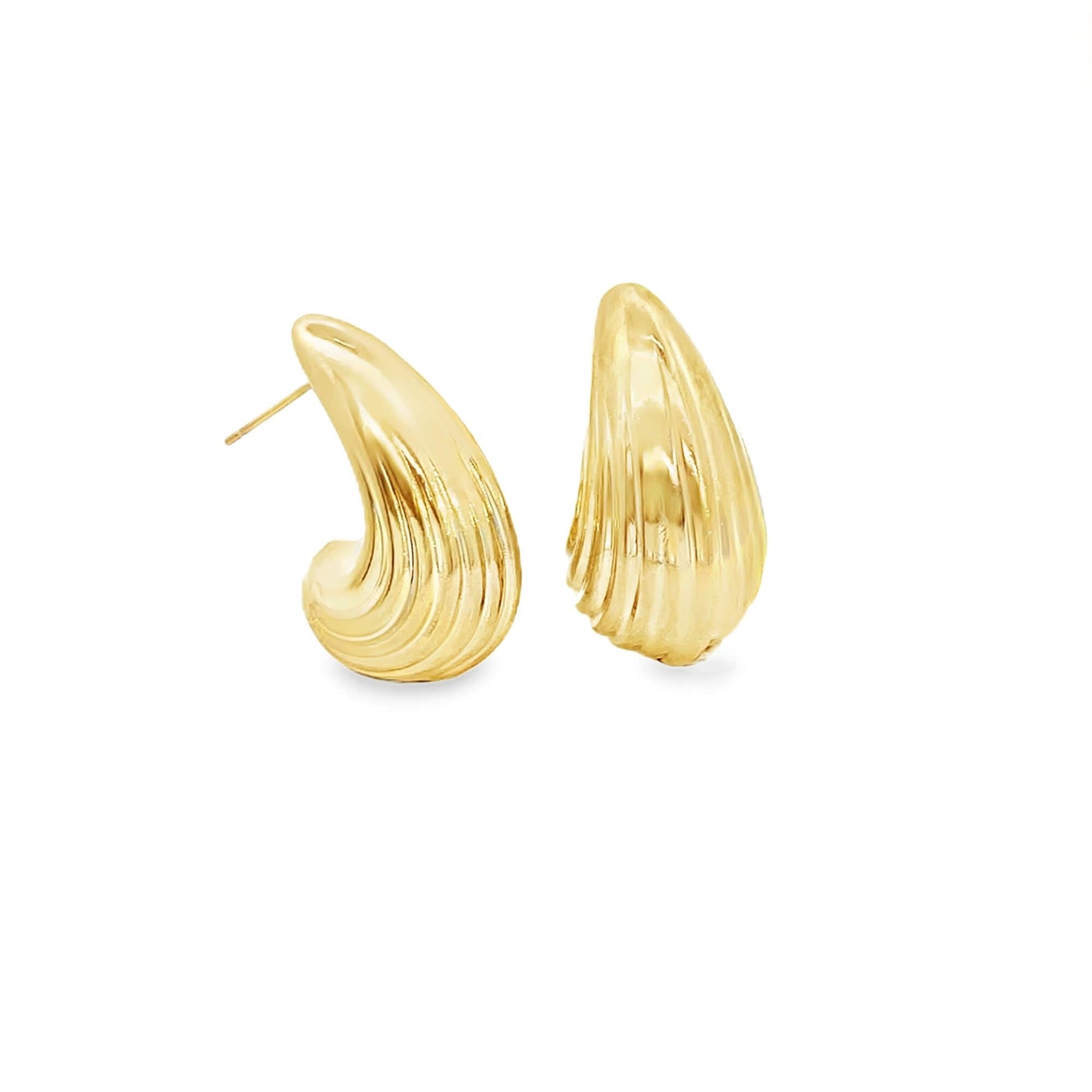 A pair of polished gold hoop earrings featuring a textured, fluted shell design rests against a clean white background.