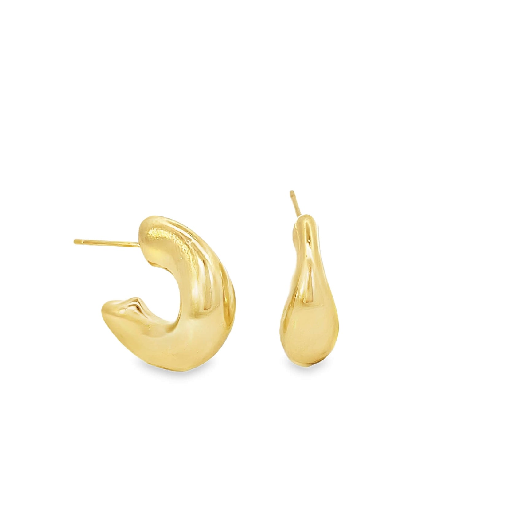 A pair of chunky gold hoop earrings rests against a clean white background, showcasing their thick, organic shape.