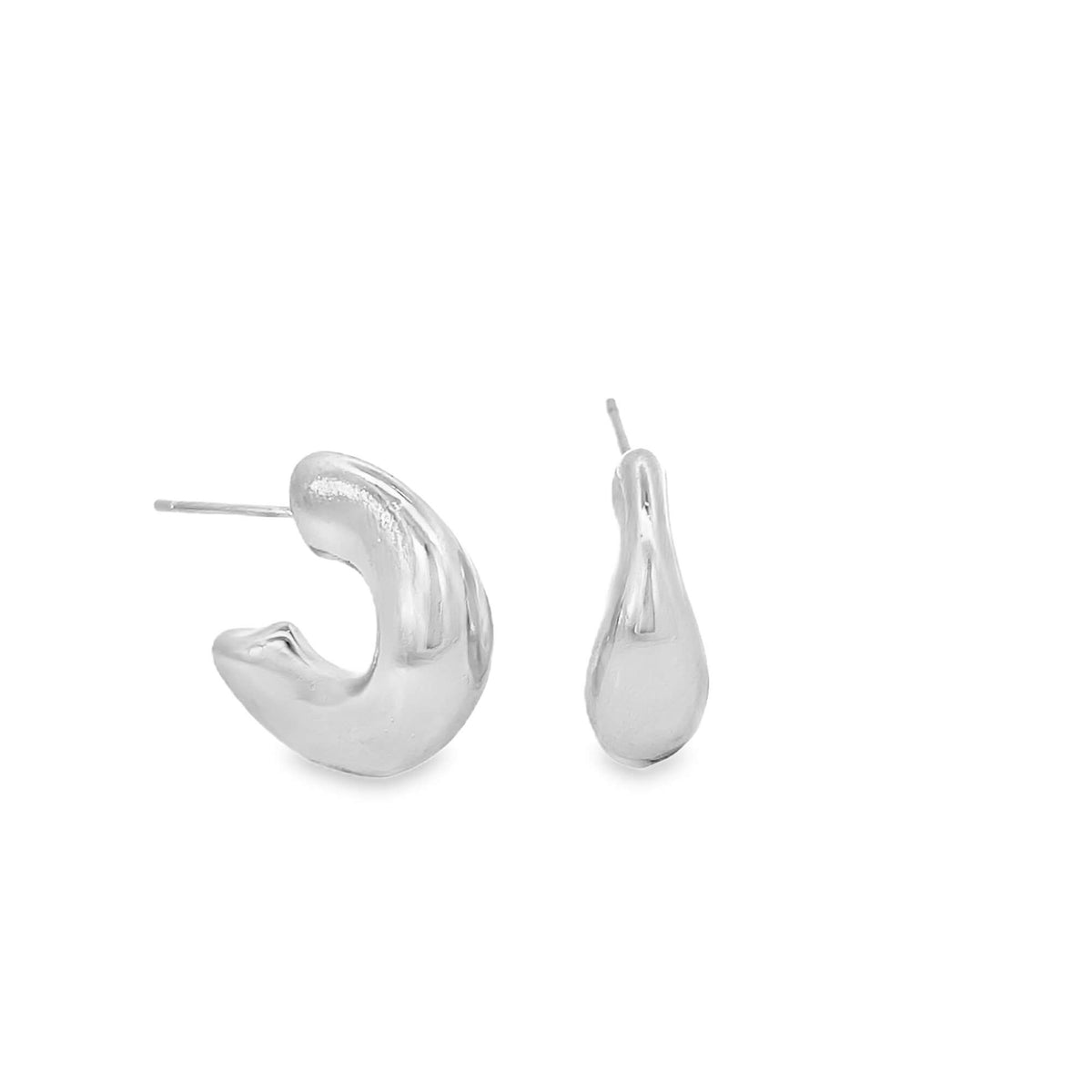 A pair of chunky silver hoop earrings rests against a clean white background, showcasing their thick, sculptural design.