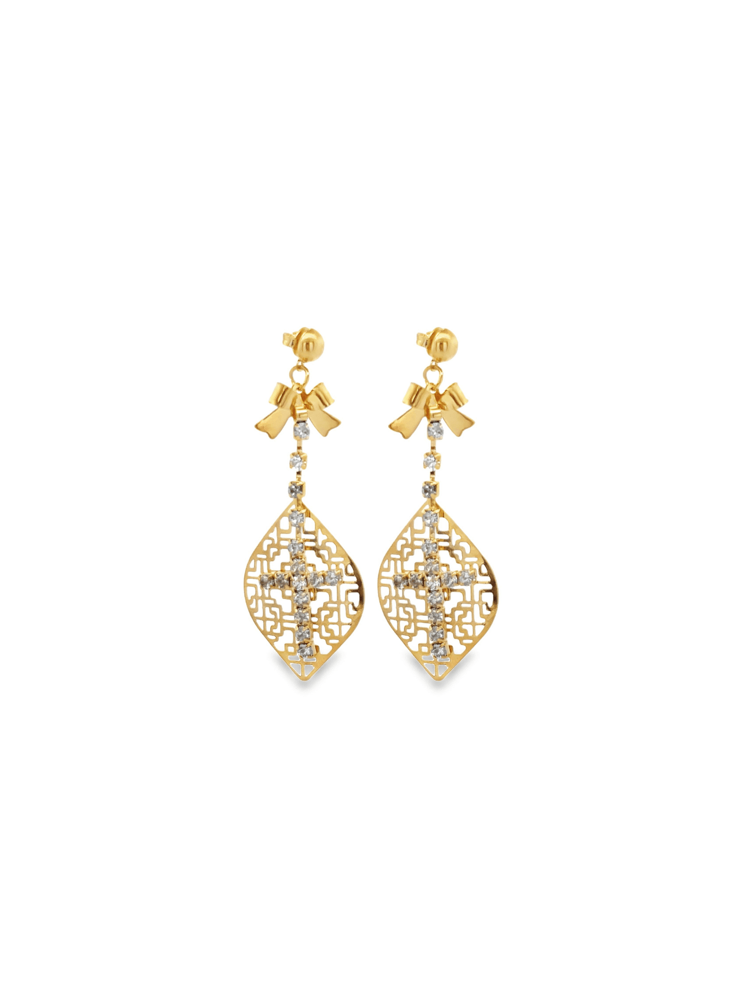 A pair of ornate gold dangling earrings features a bow top, a diamond-encrusted chain, and an intricate filigree drop pendant with a central cross.