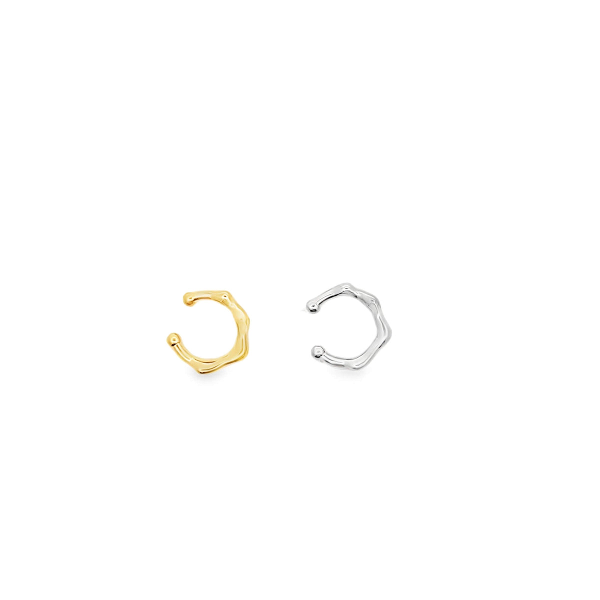 Gold and silver ear cuffs on a white background