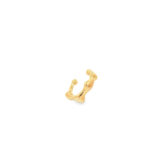 Gold ear cuff on a white background