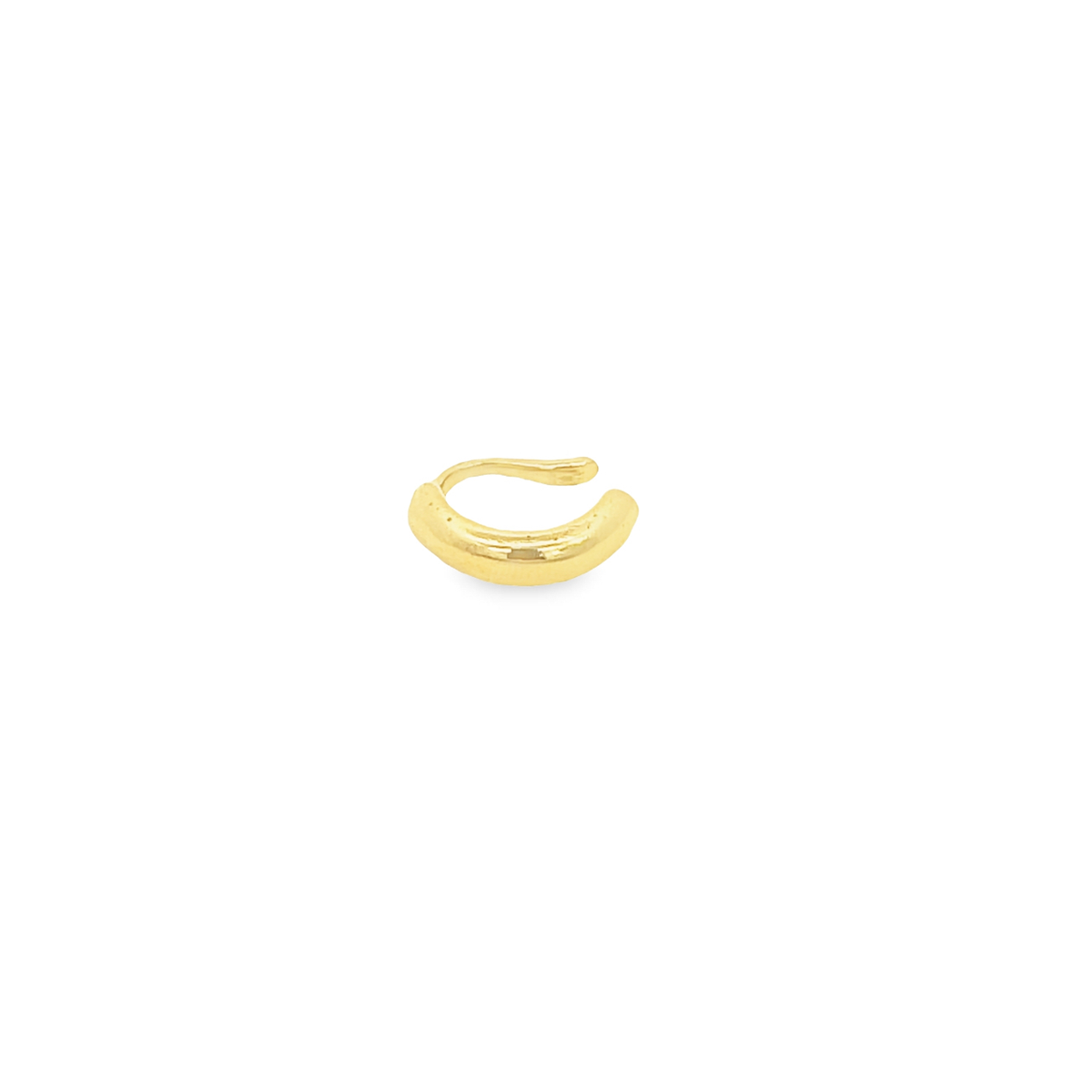 A minimalist gold ear cuff rests on a clean white background.