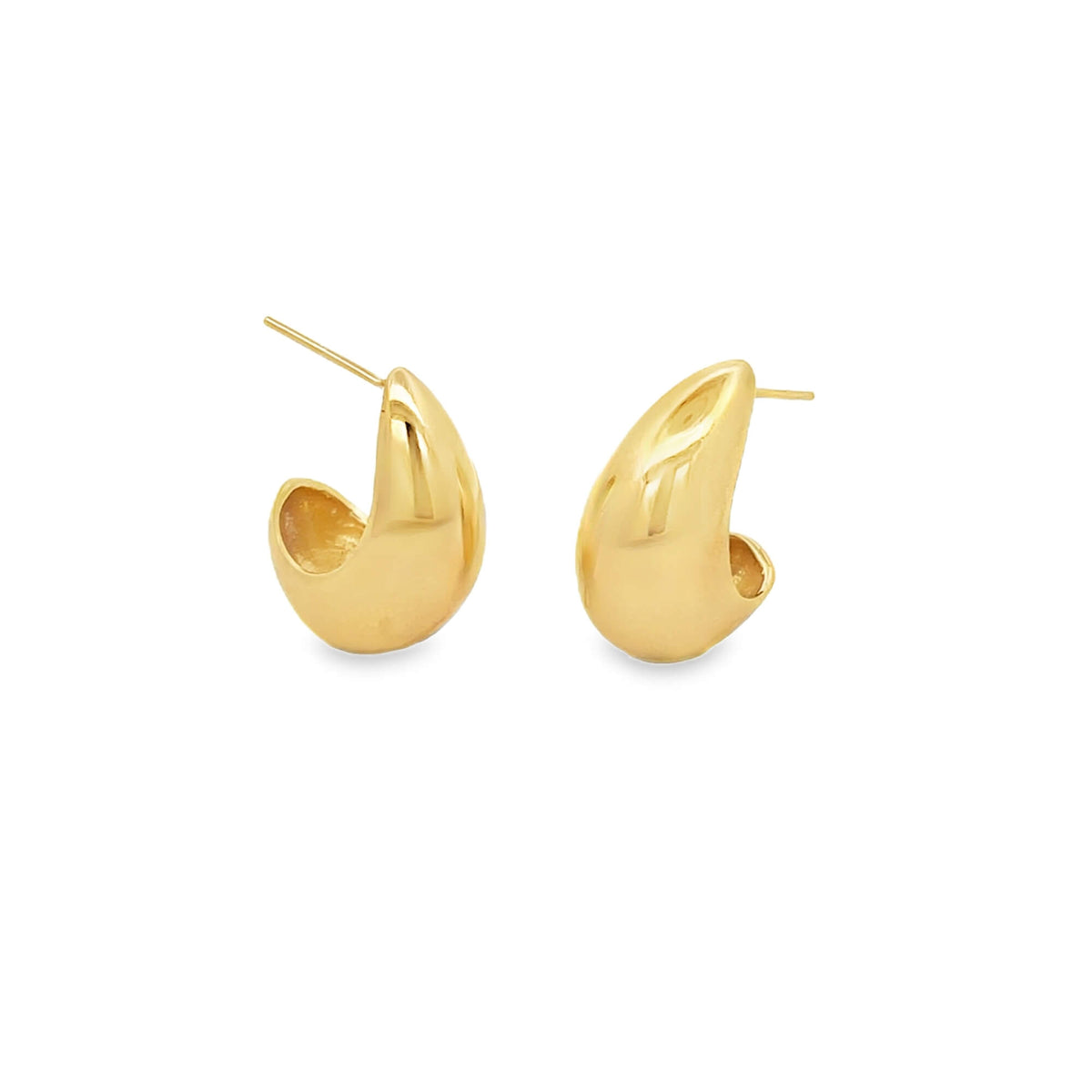 A pair of shiny gold teardrop huggie earrings resting against a clean white background.