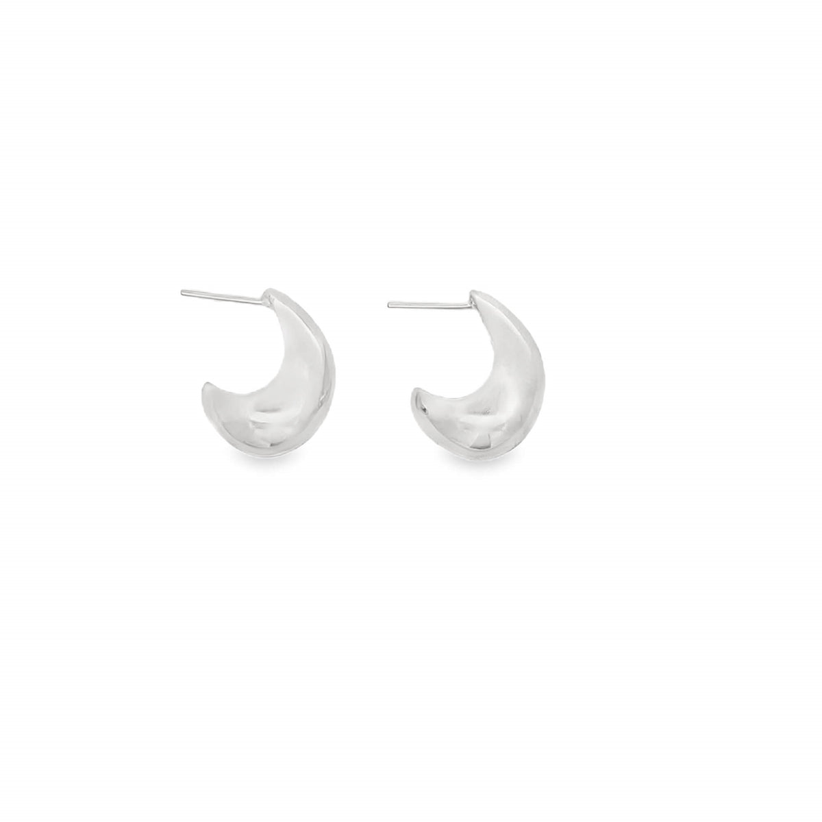 A pair of polished silver crescent-shaped huggie earrings rests against a clean white background.