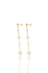 A pair of elegant gold chain drop earrings features delicate white pearls cascading down against a clean white background.