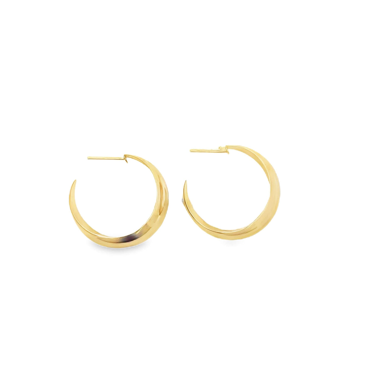 A pair of polished gold hoop earrings rests against a clean white background.