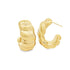 A pair of chunky gold hoop earrings with a textured, quilted design rest on a white background.