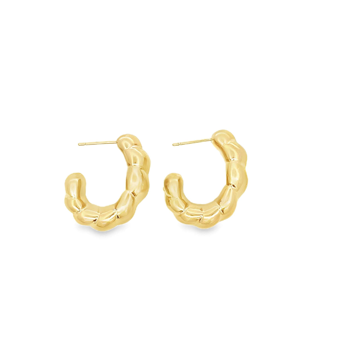 A pair of chunky gold hoop earrings with a textured, quilted design rests against a clean white background.