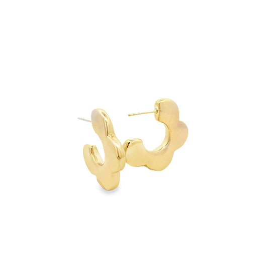 A pair of shiny gold floral hoop earrings rests against a clean white background.