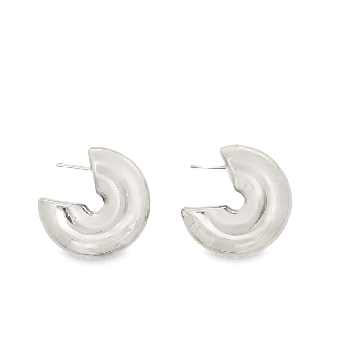 A pair of chunky silver hoop earrings feature a bold, sculptural design on a plain white background.