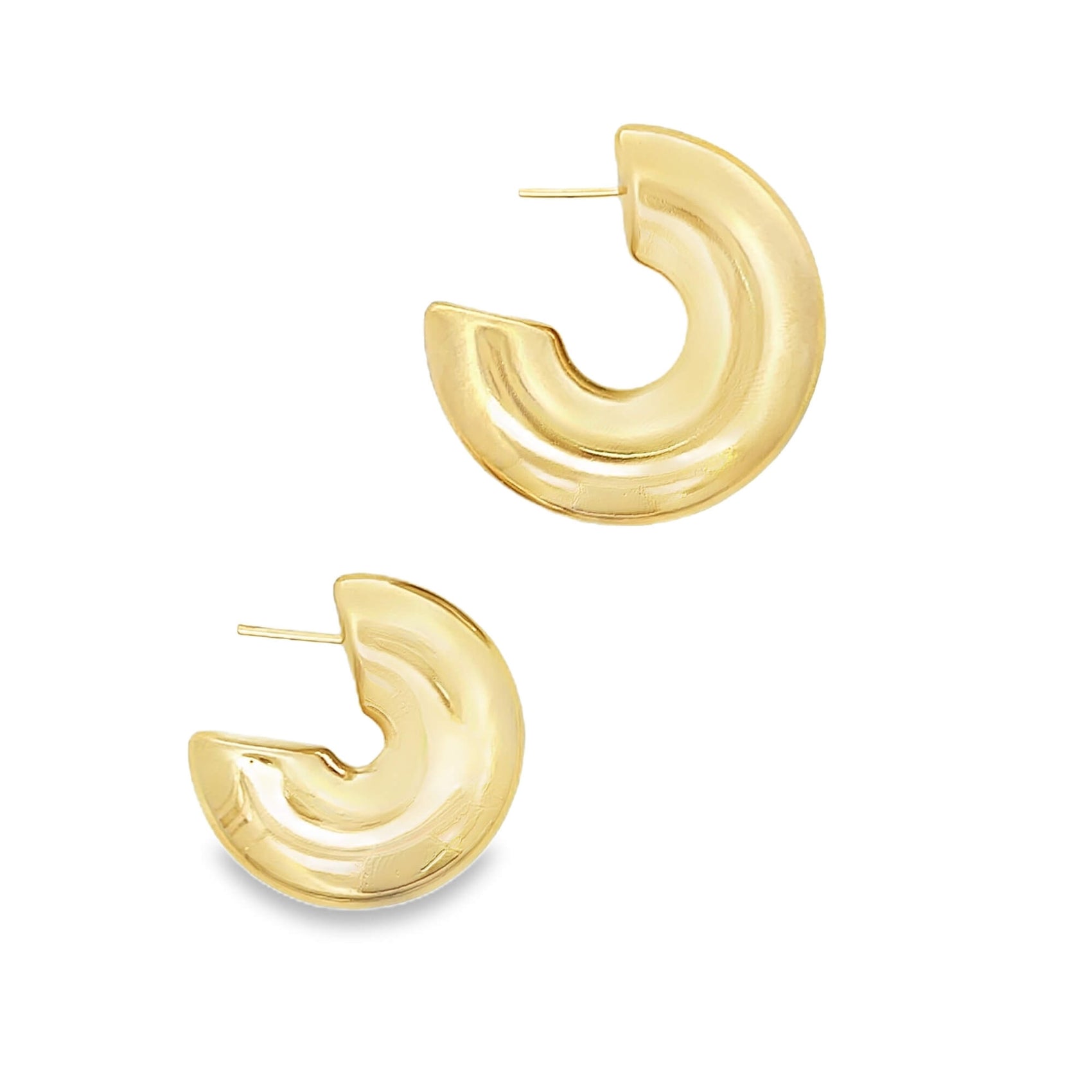 A pair of thick, polished gold hoop earrings rests against a clean white background.