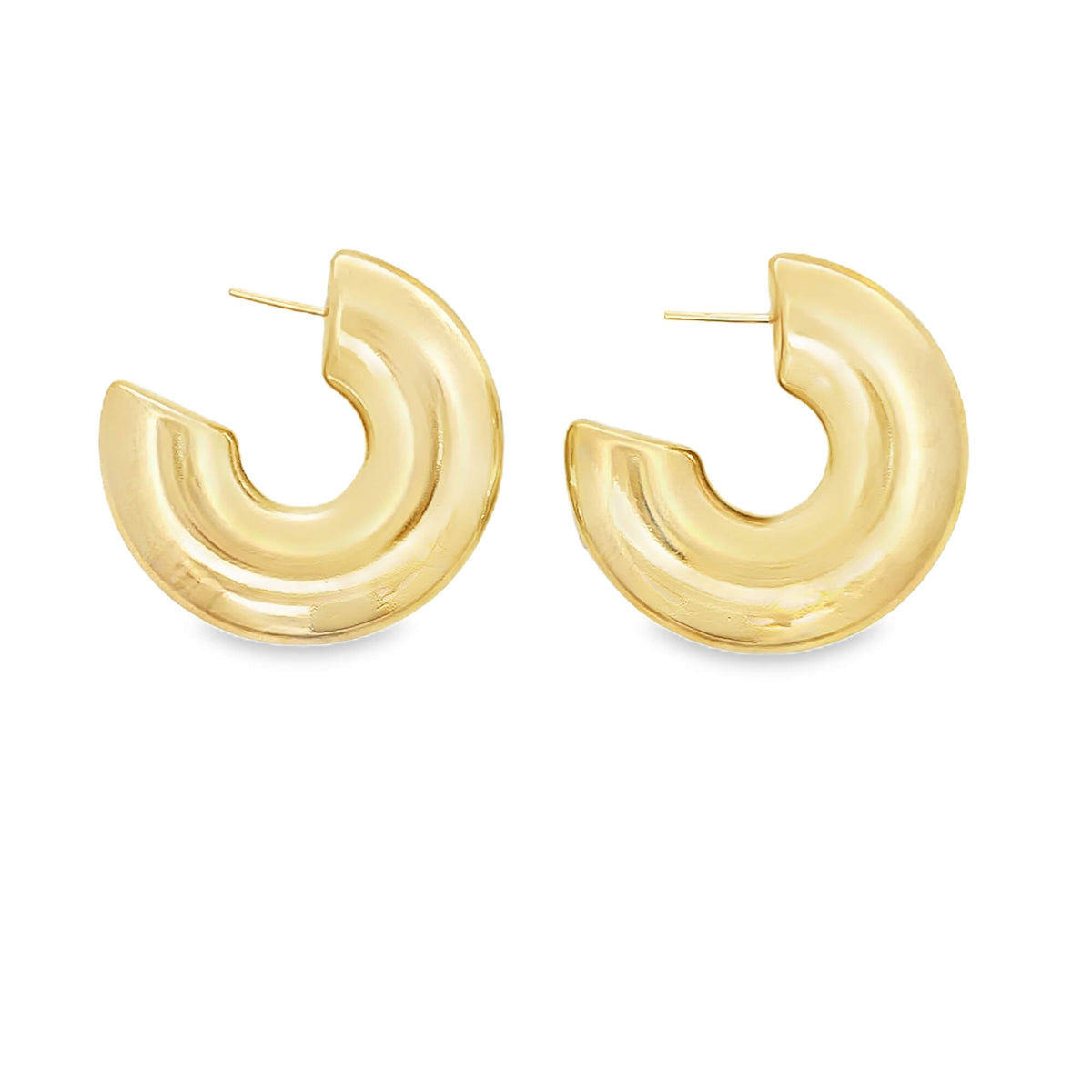 A pair of thick, polished gold hoop earrings rests against a clean white background.