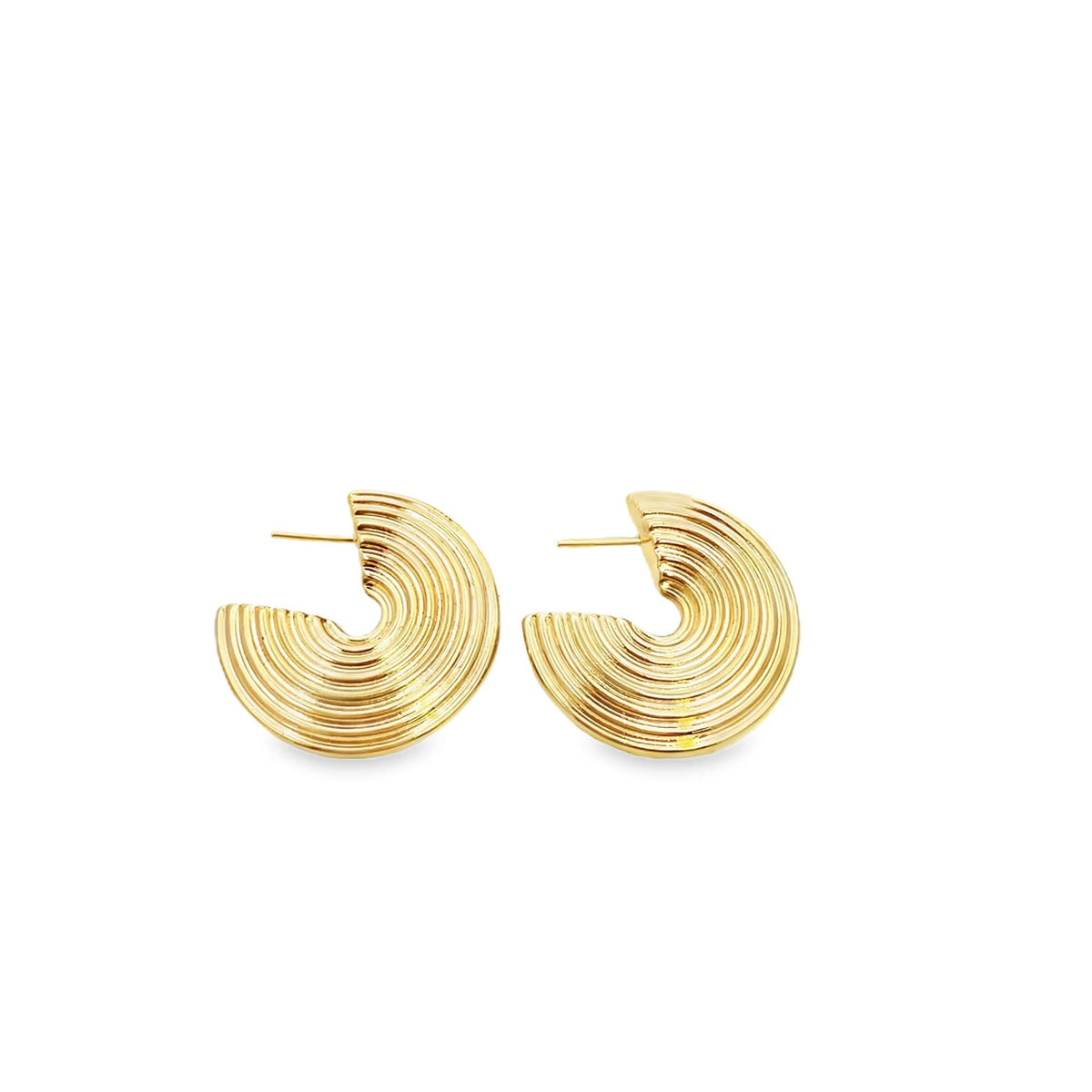 A pair of shiny gold ribbed crescent hoop earrings rests against a clean white background.