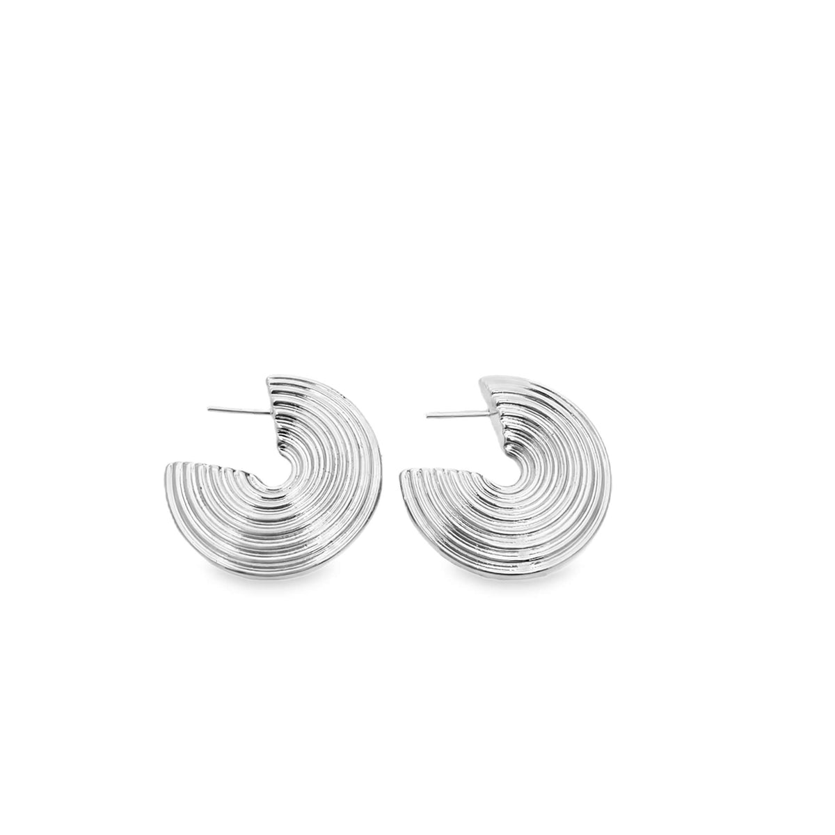 A pair of textured silver hoop earrings rests against a clean white background.