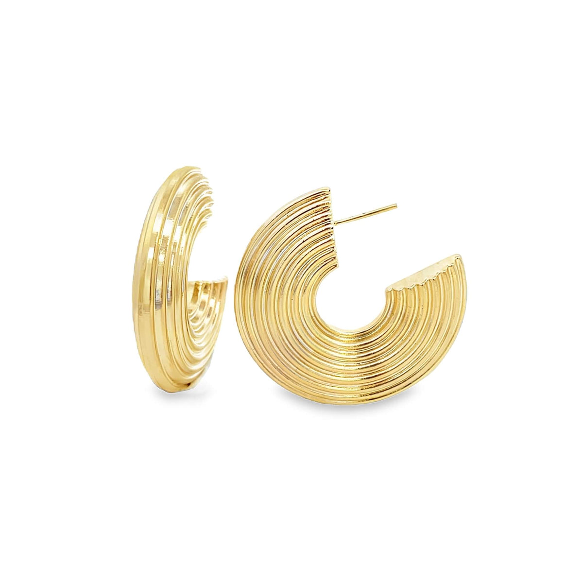A pair of chunky gold hoop earrings featuring a ribbed, textured design rests against a clean white background.
