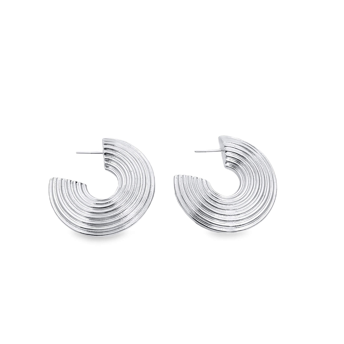 A pair of shiny silver ridged half-hoop earrings rests against a clean white background.