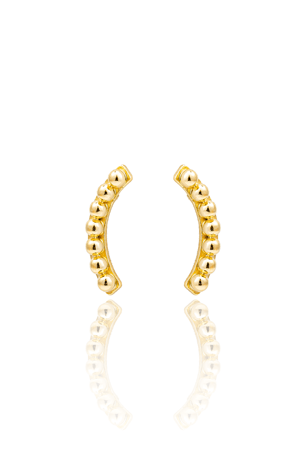 A pair of curved gold bead stud earrings is displayed against a clean white background with a soft reflection underneath.