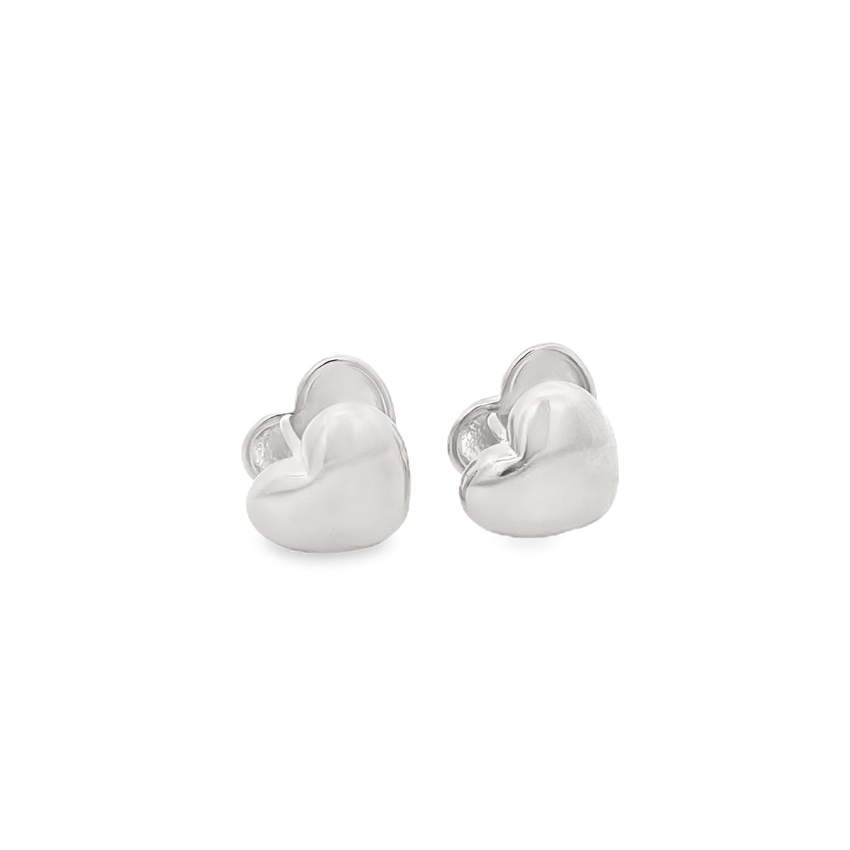 A pair of polished silver heart-shaped stud earrings rests against a clean white background.
