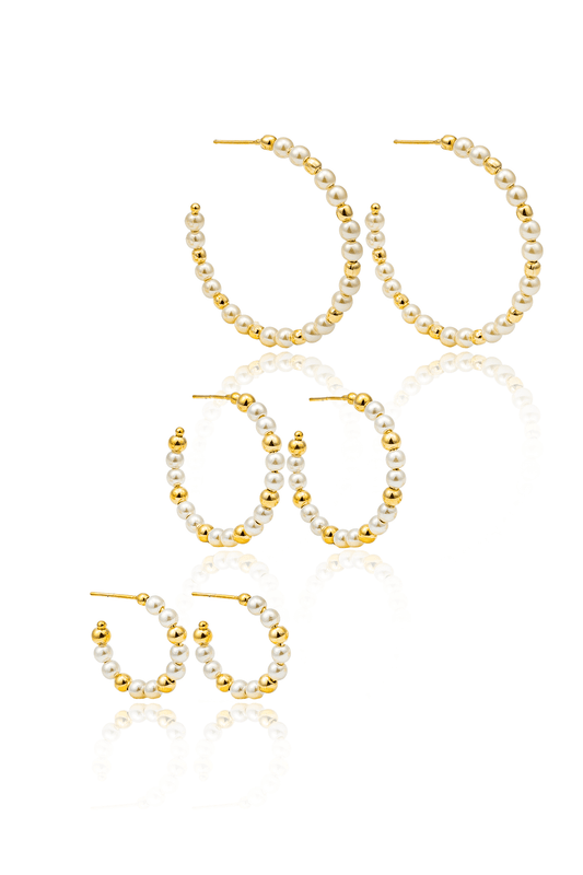 Three pairs of gold hoop earrings adorned with alternating white faux pearls and gold beads display on a white background.