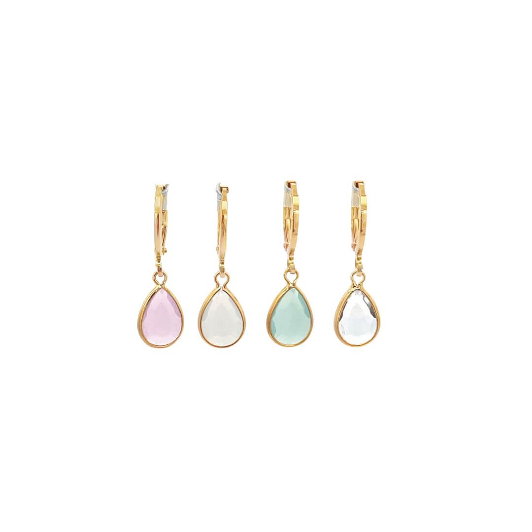 Four gold teardrop gemstone earrings featuring pink, white, green, and clear stones display their leverback closures against a plain white background.
