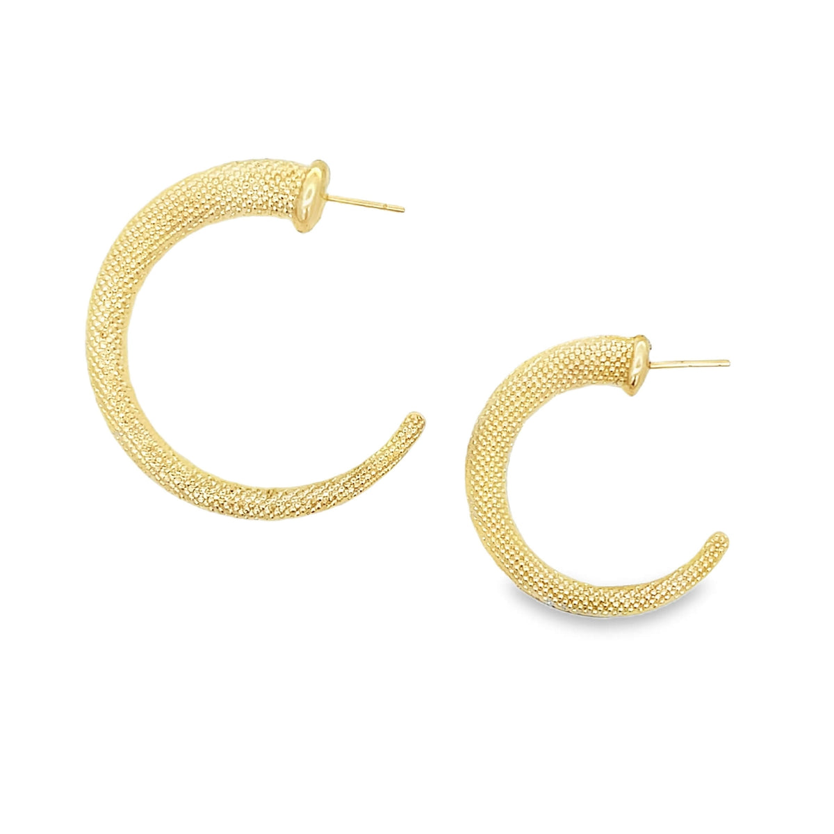 A pair of textured gold hoop earrings displays a granular, stippled finish against a clean white background.