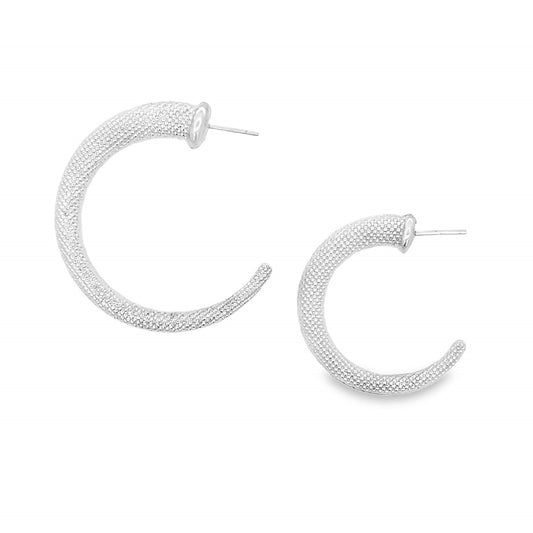 A pair of textured silver hoop earrings displays an intricate stippled pattern on a clean white background.