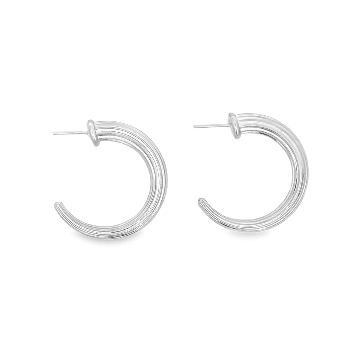 A pair of shiny silver hoop earrings rests against a clean white background.