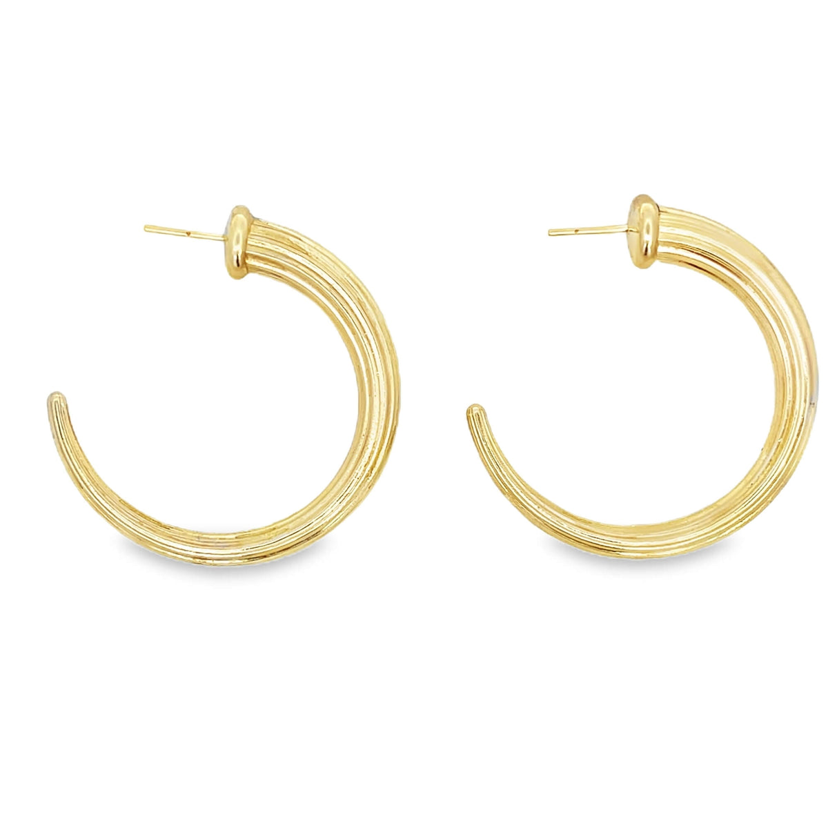 A pair of ribbed gold hoop earrings displays a polished finish against a plain white background.