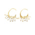 A pair of elegant gold crescent-shaped hoop earrings features dangling freshwater pearls on a clean white background.