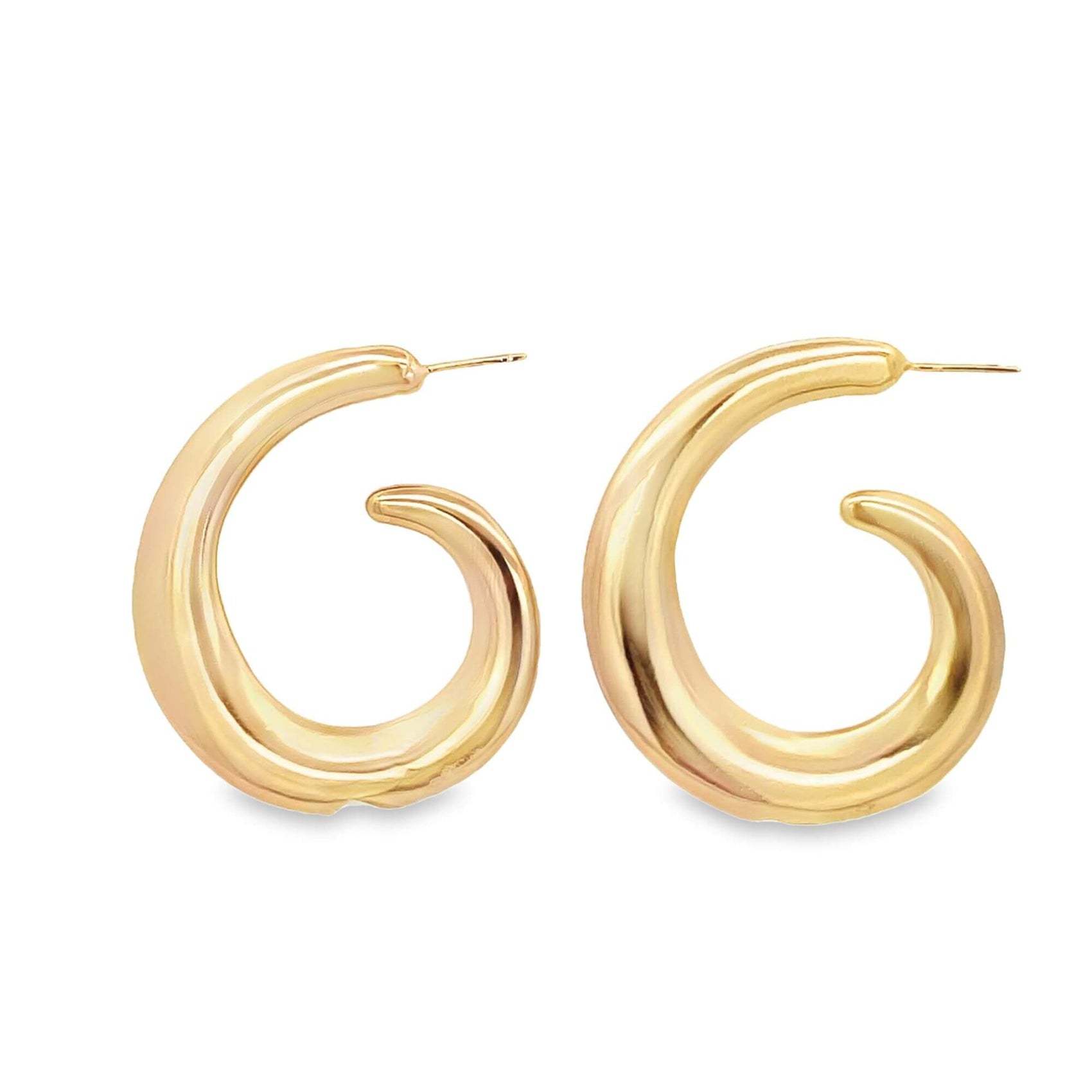A pair of thick, polished gold hoop earrings with a modern swirl design rests against a clean white background.