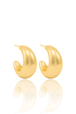 A pair of glossy gold chunky hoop earrings rests on a reflective white surface.