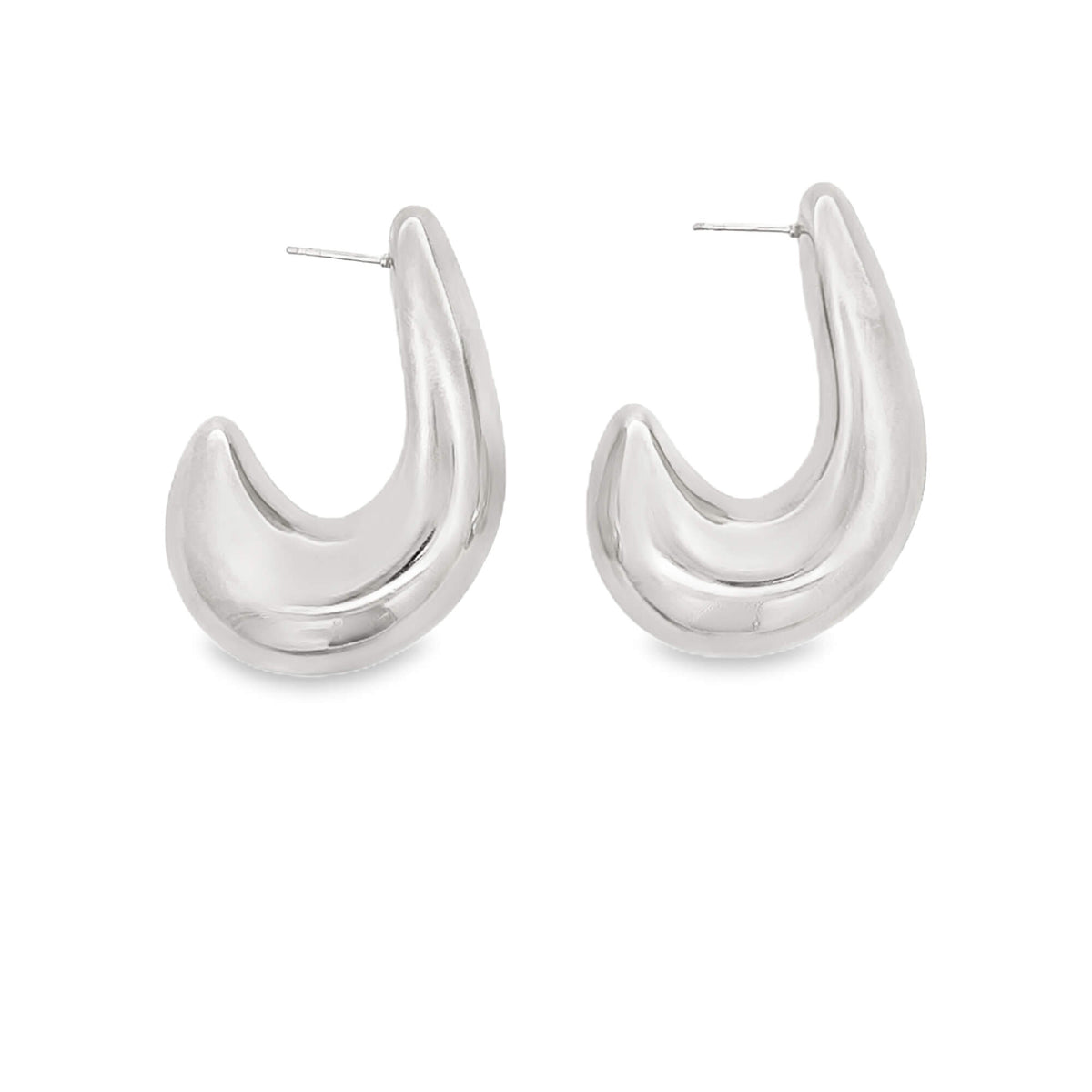 A pair of chunky silver hoop earrings rests against a clean white background.