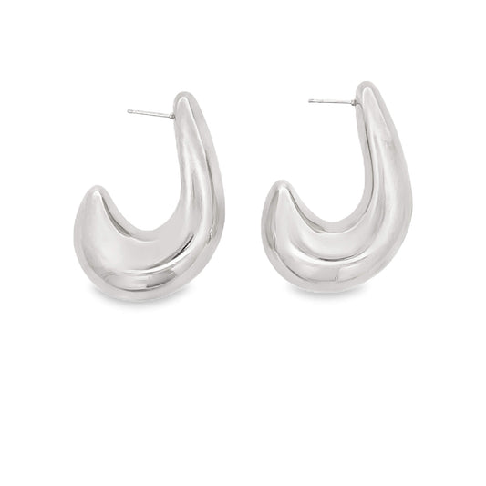 A pair of chunky silver hoop earrings rests against a clean white background.