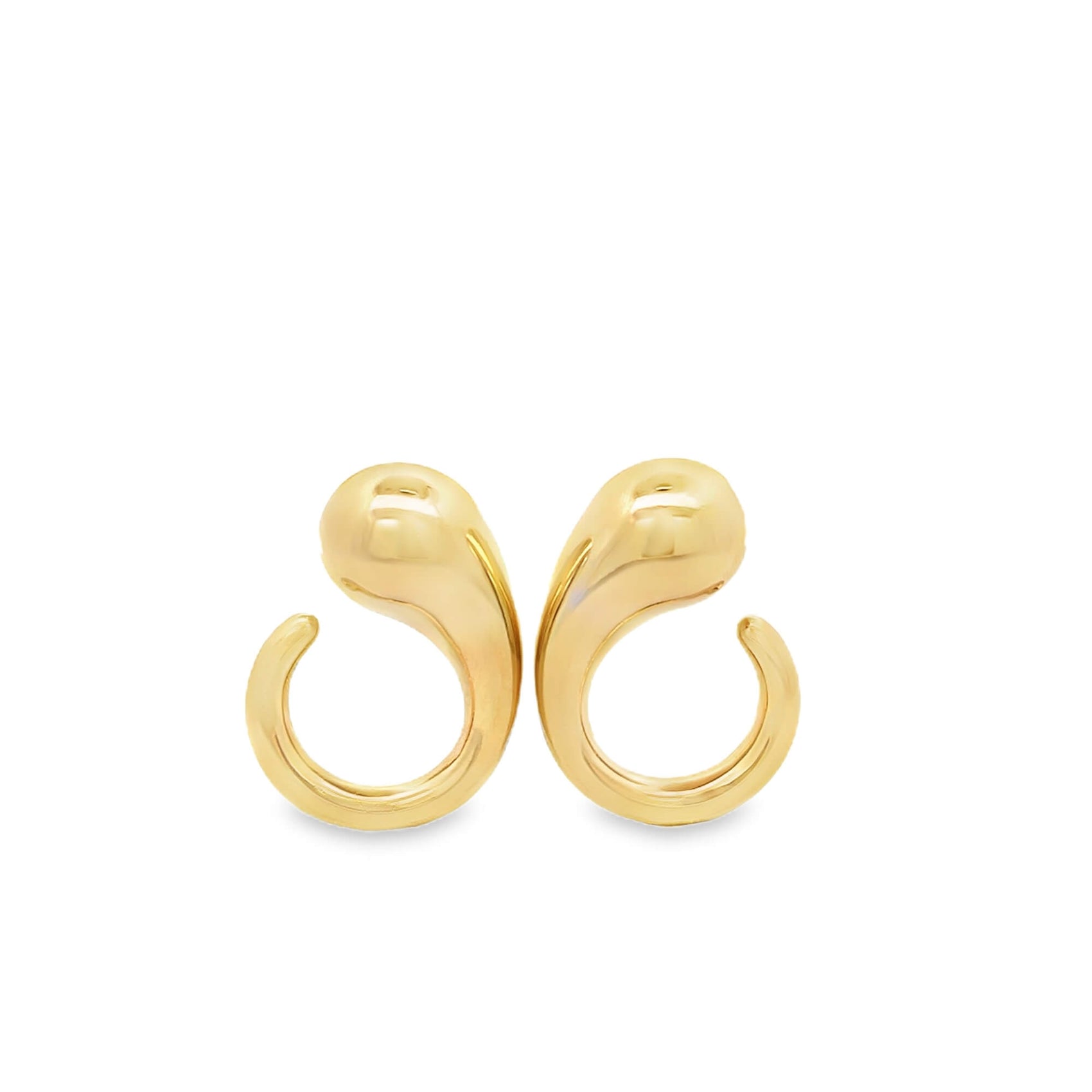 A pair of polished gold teardrop huggie earrings rest against a clean white background.