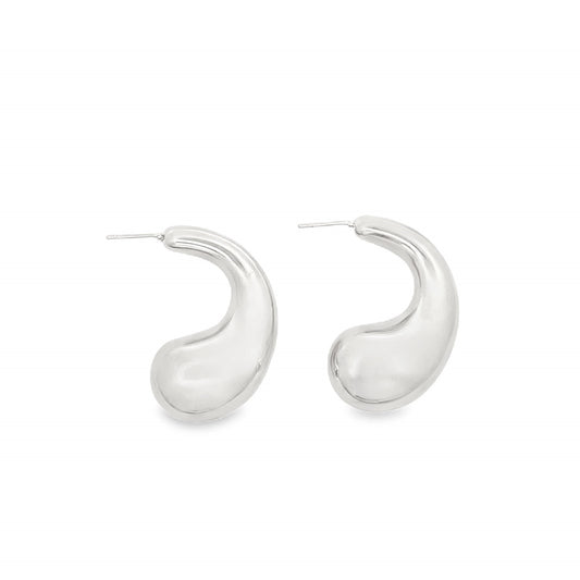 A pair of chunky silver teardrop earrings rest against a clean white background.