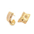 A pair of glossy gold hoop earrings rests against a white background, showcasing a modern, twisted design.