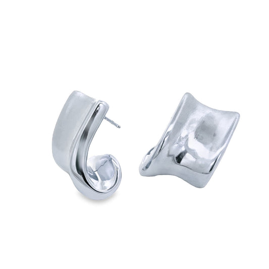 A pair of modern sterling silver hoop earrings with a uniquely curved, chunky design rests against a clean white background.