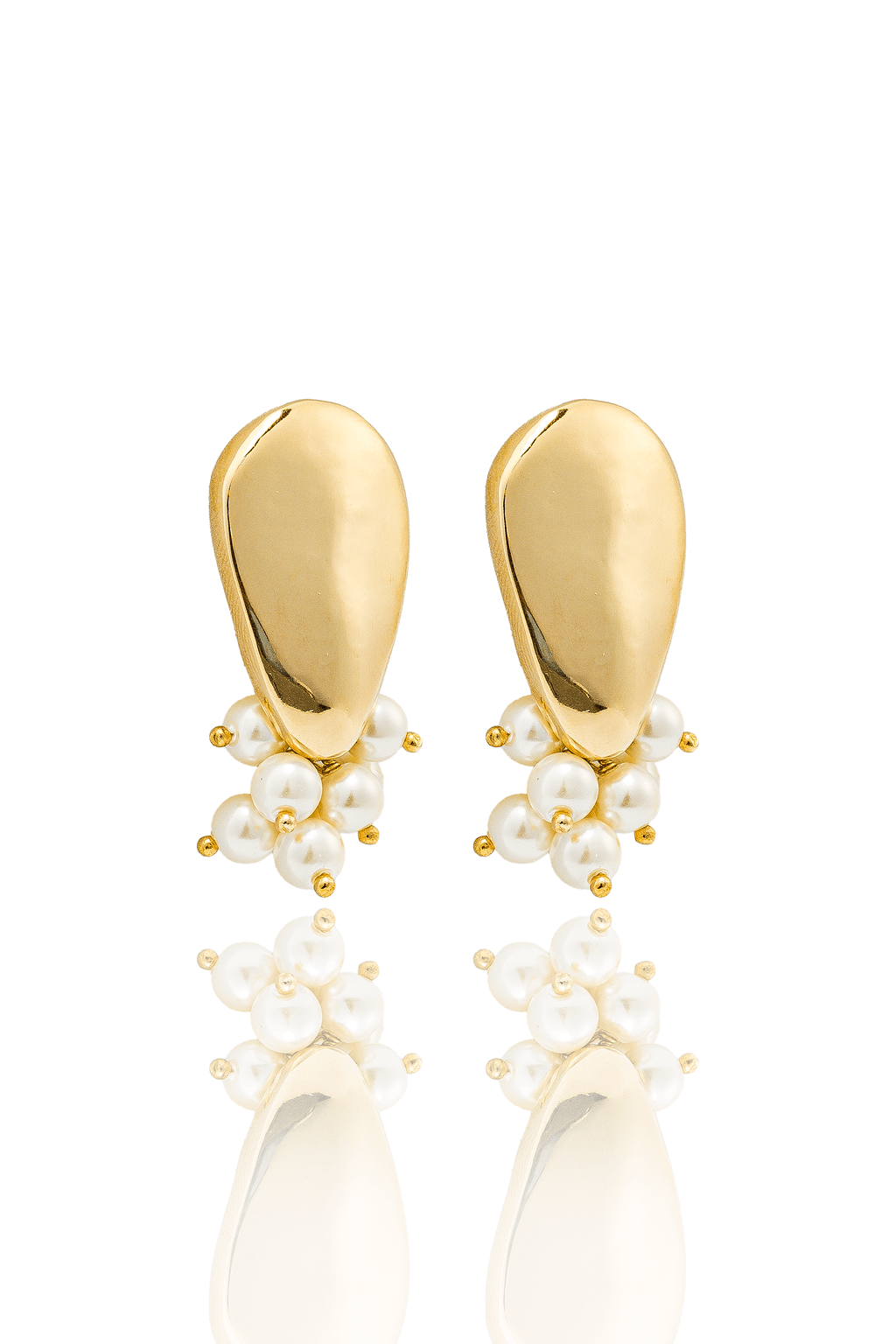 A pair of statement gold earrings features a smooth teardrop stud accented by a clustered cascade of delicate white pearls.